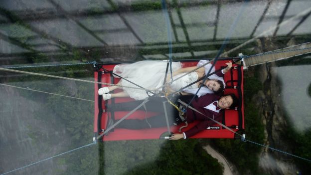 The couple suspended off Shiniuzhai glass bridge, 9 August 2016