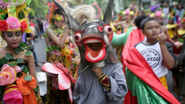 Balinese take part in a cultural parade during a New Year