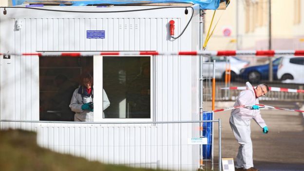 Police outside the migrant shelter that was targeted with a grenade