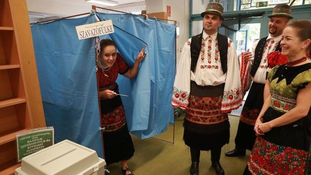 Hungarian voters wearing traditional 'Matyo' are pictured at a polling station in Mezokoevesd, eastern Hungary, voting on the referendum against EU refugee quotas on 2 October 2016