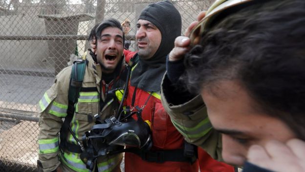 A firefighter reacts at the site of a collapsed high-rise building in Tehran, Iran (19 January 2017)