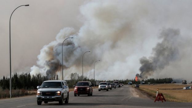 Convoy of vehicles pass wildfires - 6 May