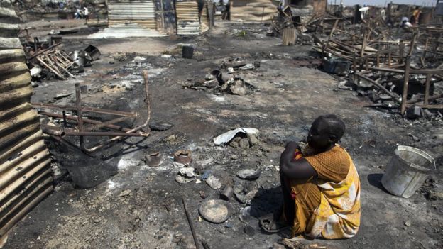 A displaced woman residing in the Protection of Civilians (PoC) site in Malakal, South Sudan, sits in the spot where her shelter used to be on 26 February, 2016.