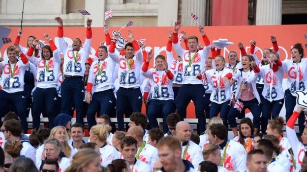 Team GB athletes start a Mexican wave on stage at Trafalgar Square