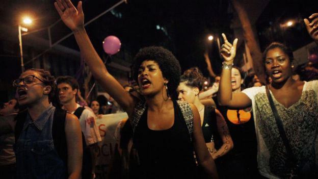 Activists and supporters chant during a march for women's rights on International Women's Day on 8 March 2016 in Rio de Janeiro, Brazil