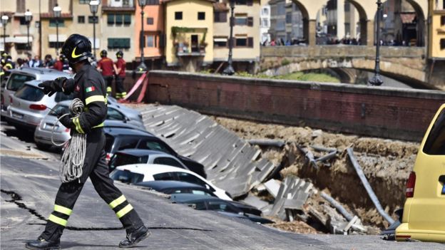 A firefighter walks next to a chasm near Ponte Vecchio, Florence, Italy, 25 May 2016