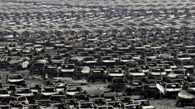 Damaged cars are seen near the site of the explosions at the Binhai new district, Tianjin, 13 August 2015.