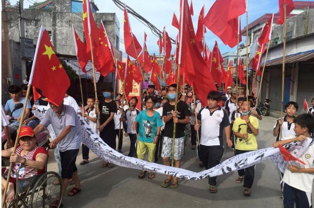 Villagers, including schoolchildren, hold a protest march demanding the release of their village chief Lin Zuluan, in Wukan on 21 June.