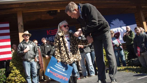 Republican presidential candidate John Kasich (right) speaks with a young supporter at a rally in South Carolina