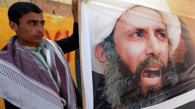 A Yemeni protester holds a picture of Sheikh Nimr in 2014