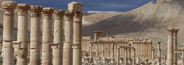 This file photo taken on March 14, 2014 shows Syrian citizens riding their bicycles in the ancient oasis city of Palmyra