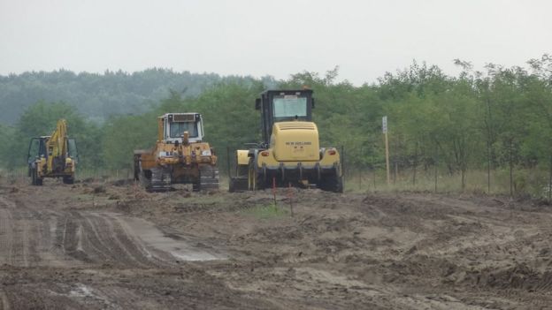Diggers prepare land for the border fence
