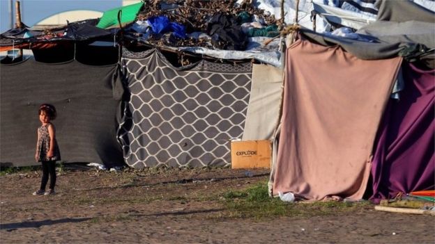 A refugee child stands outside her tent on the Hungary-Serbia border, in a camp outside a transit zone set up by Hungarian authorities to filter refugees at Roszke, Hungary, September 2, 2016