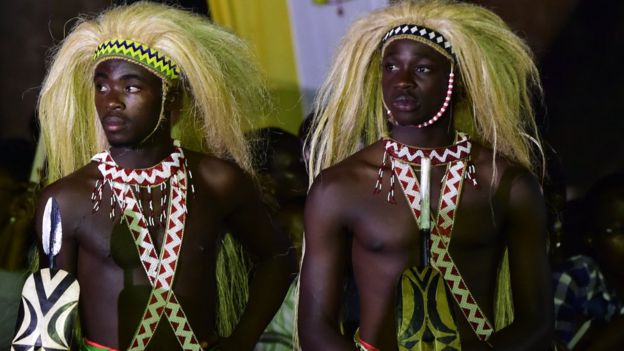 Men dressed in traditional clothes during a visit by Pope Francis with the Munyonyo community on November 27, 2015 in Kampala