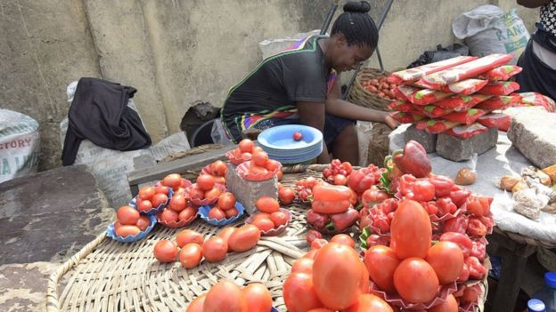 A vendor arranges tomatoes on display in the Obalende district of Lagos, on May 25, 2015