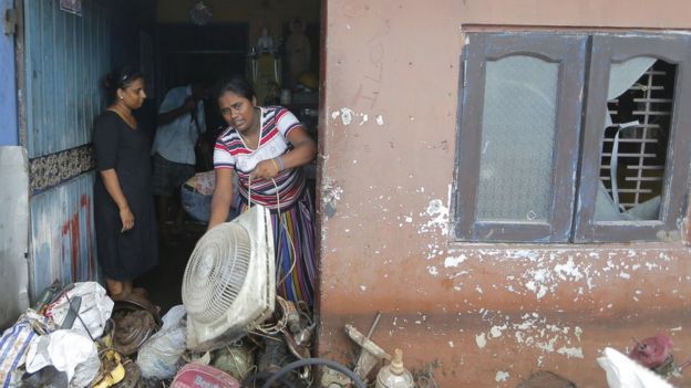 Sri Lankan flood victims clean their house as the water level starts to decline in Colombo, Sri Lanka, Sunday, May 22, 2016.
