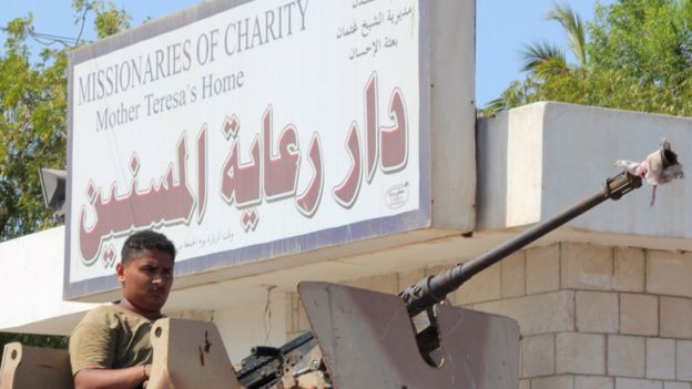 Yemeni pro-government fighters, loyal to exiled Yemeni President Abedrabbo Mansour Hadi, gather outside an elderly care home in Yemen's main southern city of Aden after it was attacked by gunmen on March 4, 2016