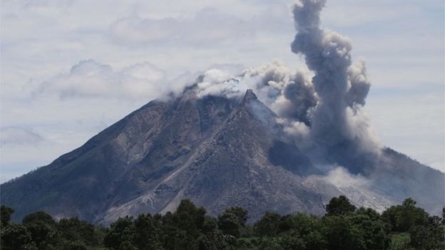 The Sinabung volcano spews hot clouds of ash, as seen from the Simpang Empat subdistrict in Karo, North Sumatra on May 22, 2016.
