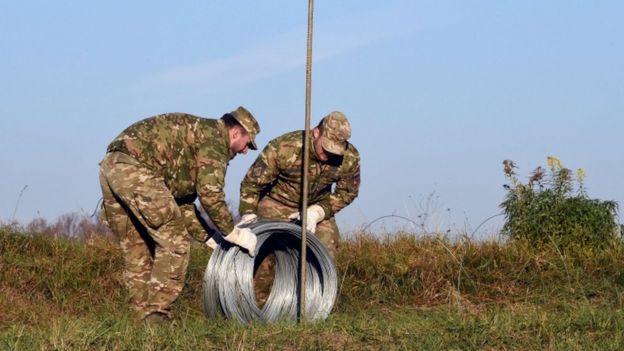 Slovenian soldiers build obstacles on the Slovenian-Croatian border on 11 November 2015