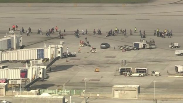 Hundreds of people have been forced to wait on the airport tarmac for police to clear the terminal