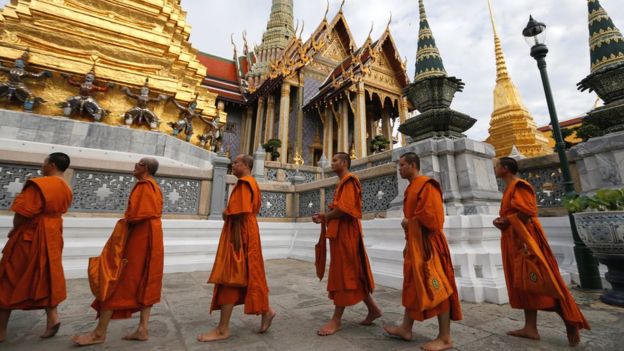 Buddhist monks arrive for a ceremony at the Grand Palace to commemorate Thailand