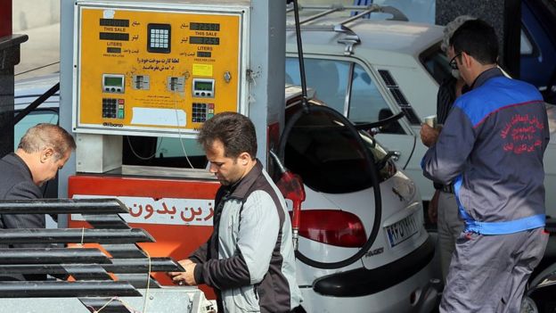Iranians fill up their cars at a petrol station in the Iranian capital Tehran on October 20, 2015