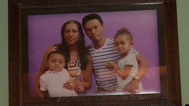 A photo on a wall of Feyisa Lilesa and his wife and children