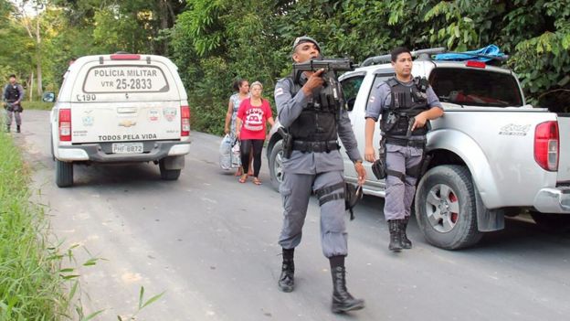 Military police officers track for fugitives of the Anisio Jobim Penitentiary Complex after a riot in the prison left at least 56 people killed and several injured, in Manaus