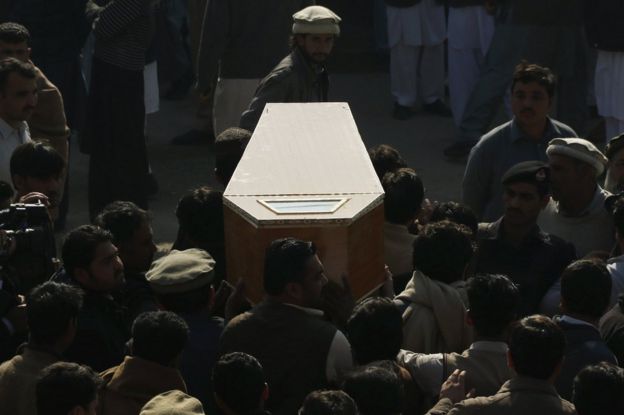 Men surround a student's coffin in Charsadda, Pakistan, 20 January