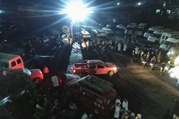Rescuers and vehicles congregated at night outside the mine in Chongqing, China, 31 October 2016.