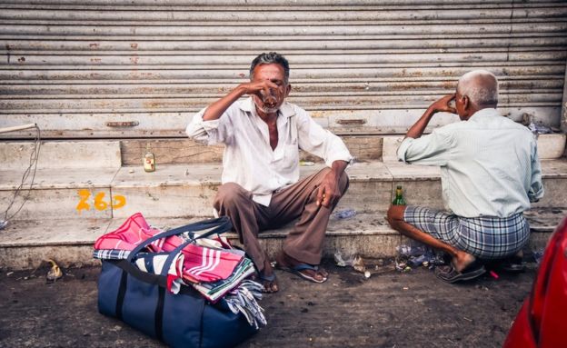 Men drinking near a Tasmac store