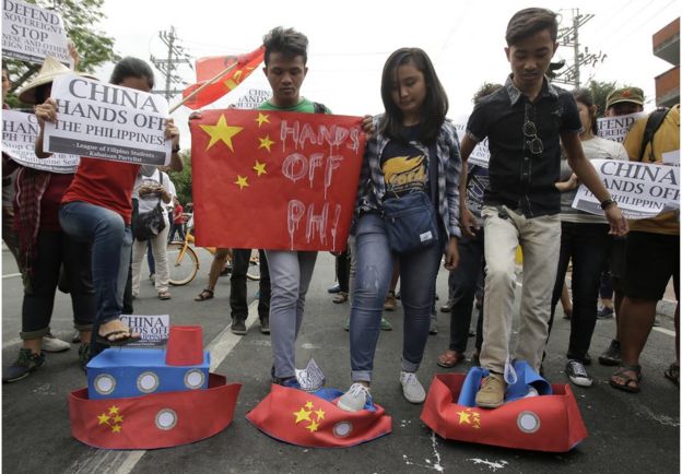 Filipino student activists step on mock Chinese ships to protest recent island-building and alleged militarization by China off the disputed Spratlys group of islands in the South China Sea during a rally near the Malacanang presidential palace in Manila, Philippines, Thursday, 3 March 2016.