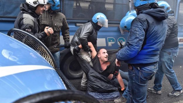 A protestor is arrested during clashes between police and protesters at an anti-government demonstration in Florence