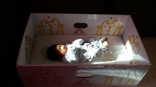 A baby sleeping in baby box