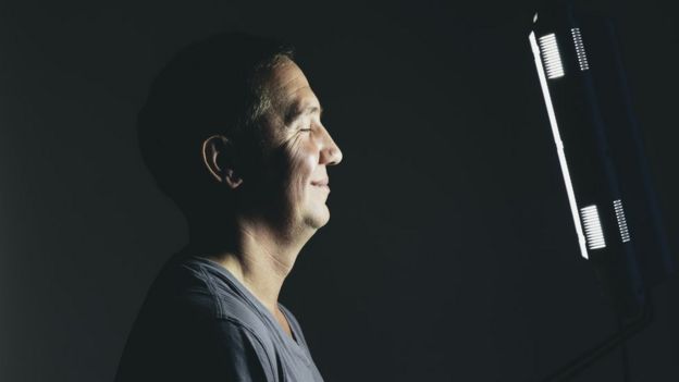 Man in front of a light box