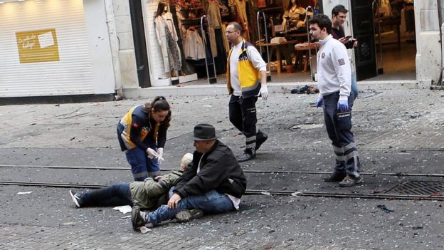 Medics try to help wounded people after an explosion in Istiklal Street in Istanbul