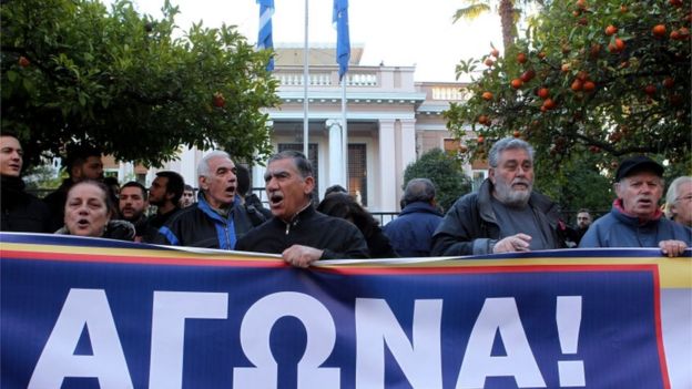 Protestors of the Communist-affiliated trade union PAME shout slogans during a protest against the new pension system reforms, outside the Maximos Mansion, in Athens, 8 January 2016