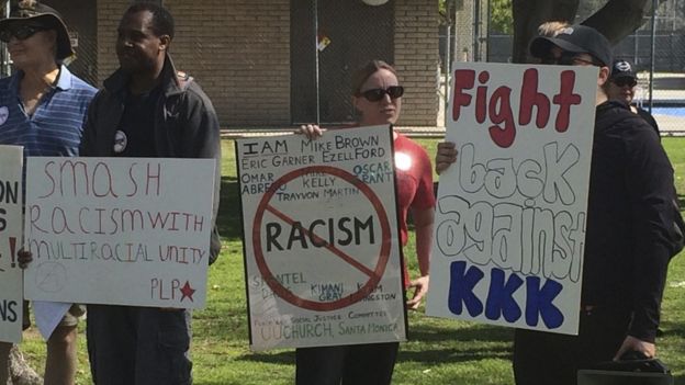 Counter protesters hold placards near a planned Klu Klux Klan rally in Anaheim, California February 27, 2016