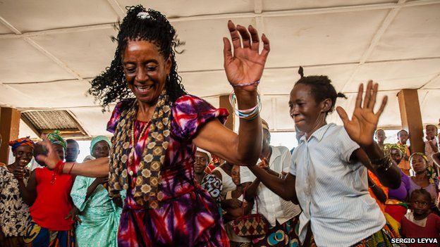 Elvira Fumero dances with villagers in Mokpangumba