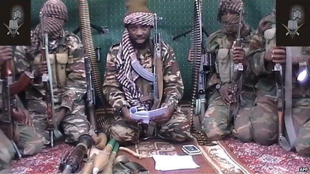 This screen grab taken on 25 September 2013 from a video distributed through an intermediary to local reporters and seen by AFP, shows a man claiming to be the leader of Nigerian Islamist extremist group Boko Haram Abubakar Shekau, flanked by armed men.