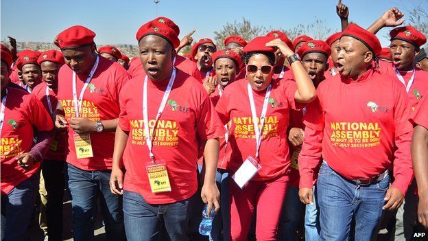 South African populist politician Julius Malema (3rd L) and comrades sign as they attend the first national assembly of his new leftist political party Economic Freedom Fighters (EFF) at Hector Pieterson Memorial in the Johannesburg township of Soweto in Jily 2013