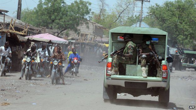 Joint Military Task Force (JTF) patrol the streets of restive north-eastern Nigerian town of Maiduguri, Borno State, on 30 April 2013