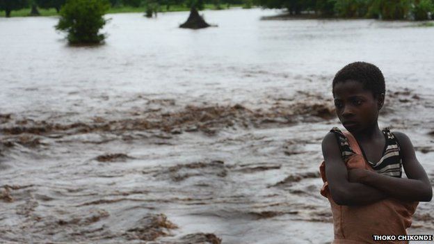 A boy stands whose family home was washed away by floods in the southern district of Chikwawa in Malawi on Tuesday 13 January 2015