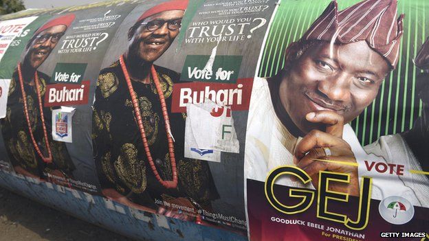 A poster of Nigerian President Goodluck Jonathan (R) and presidential candidate of the ruling People's Democratic Party (PDP) is displayed side by side with leading opposition All Progressive Congress presidential candidate Mohammadu Buhari along the highway in Lagos