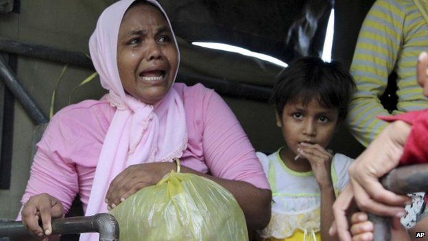 An ethnic Rohingya woman who was on one of the boats washed ashore on Sumatra island weeps as she boards a military truck heading to a temporary shelter in Seunuddon, Aceh province, Indonesia, Sunday, May 10, 2015