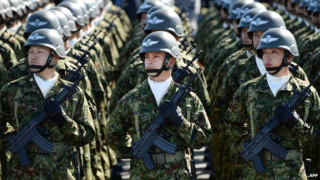 Japanese soldiers listen to Prime Minister Shinzo Abe during the military review at the Ground Self-Defence Force's Asaka training ground on October 27, 2013.
