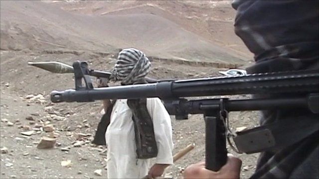 Taliban fighters holding weapons