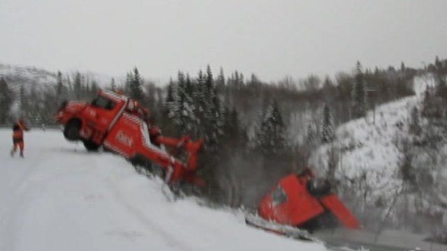 Truck falls from road