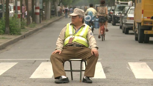 Man policing road block for students