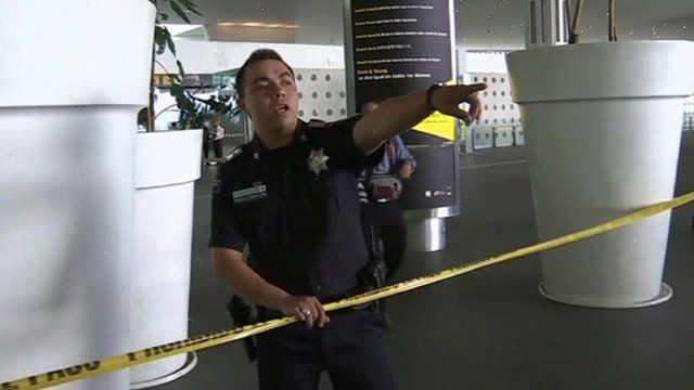 Policeman at the scene of a shootout in Mexico City's main airport.